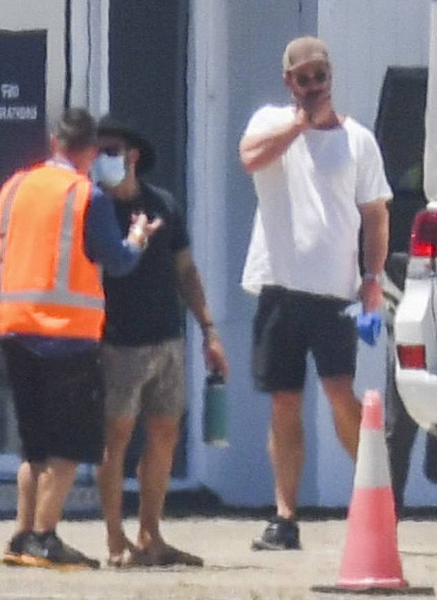 Action: Chris Hemsworth, 37, (pictured) covered his famous physique in a white shirt and shorts as he flocked to Sydney to start filming Thor: Love and Thunder on Wednesday
